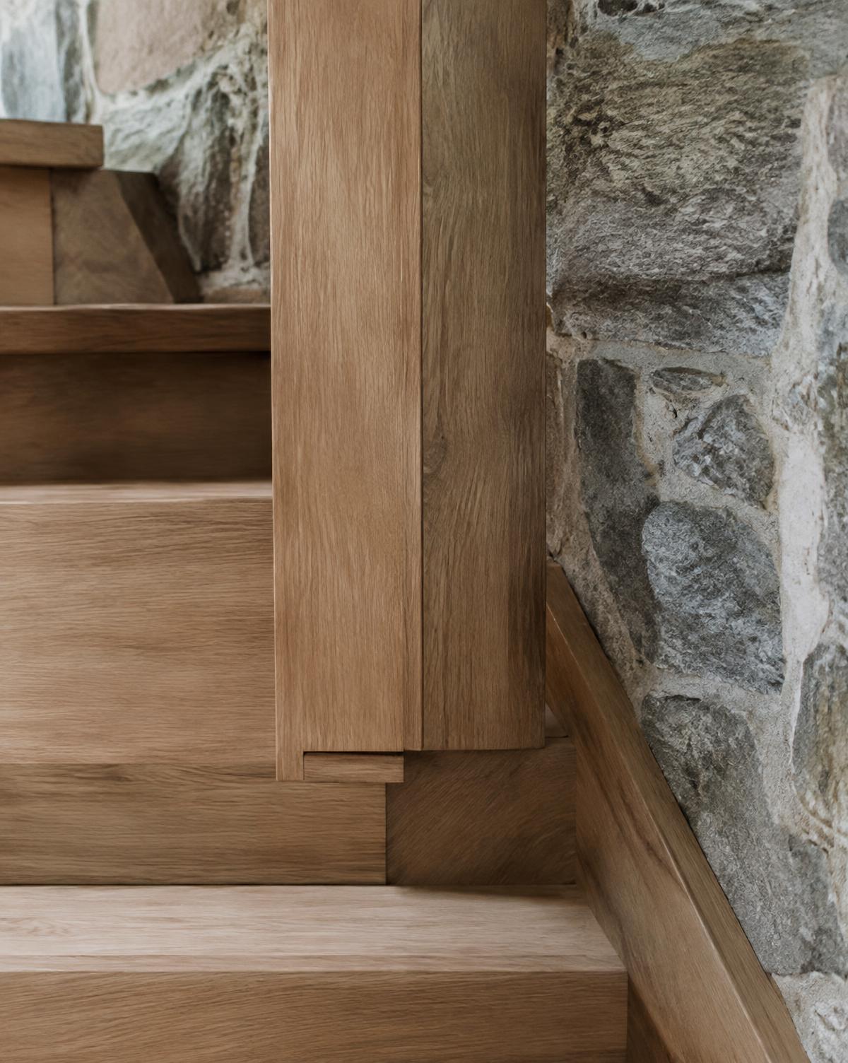 Precise oak joinery meeting a stone wall