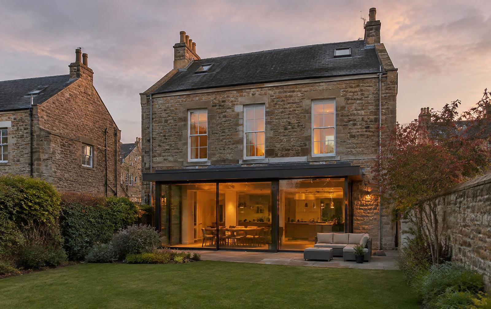 Glazed rear extension on a sandstone Edinburgh villa at dusk